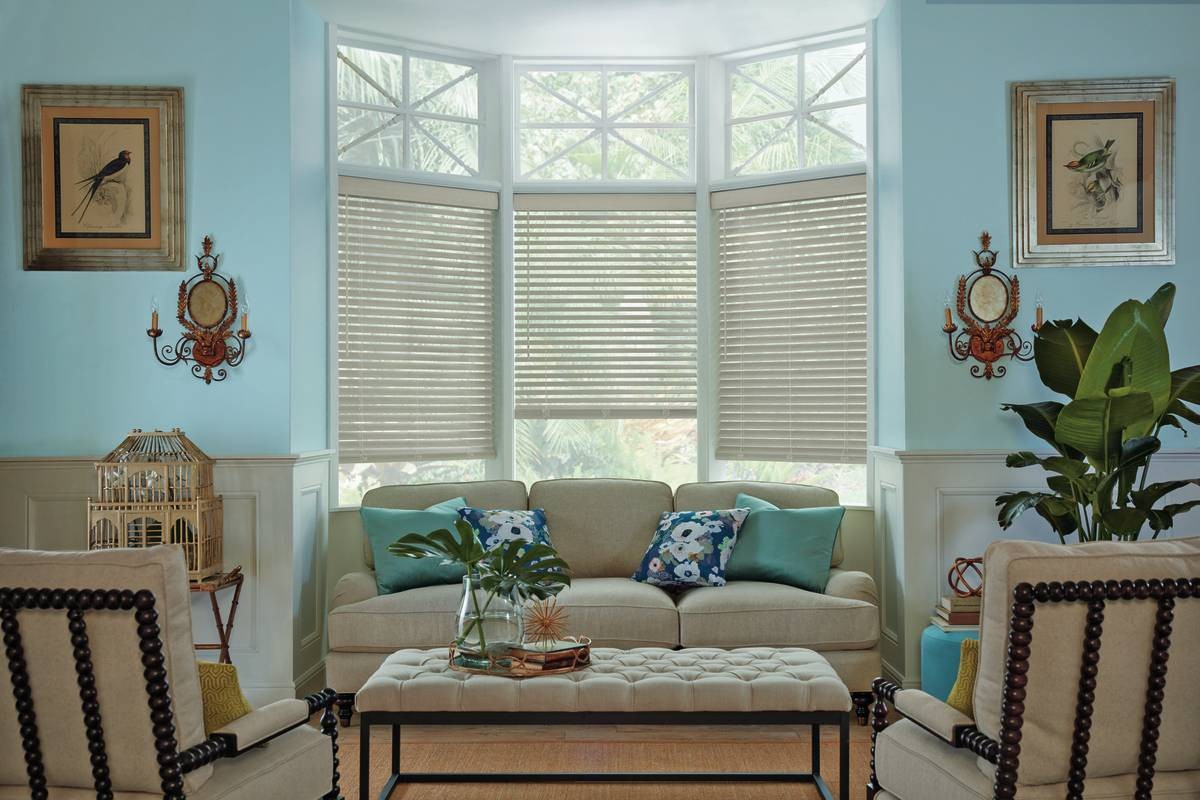 Hunter Douglas Parkland® Wood Blinds filtering light into a transitional-themed living room in La Quinta, CA
